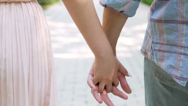 Man and woman holding hands tightly, romantic couple facing challenge together - Footage, Video