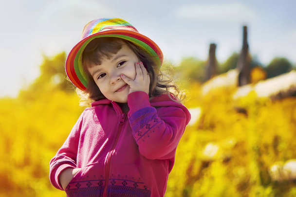 Child in a hat in rural style. Selective focus.  - Photo, Image