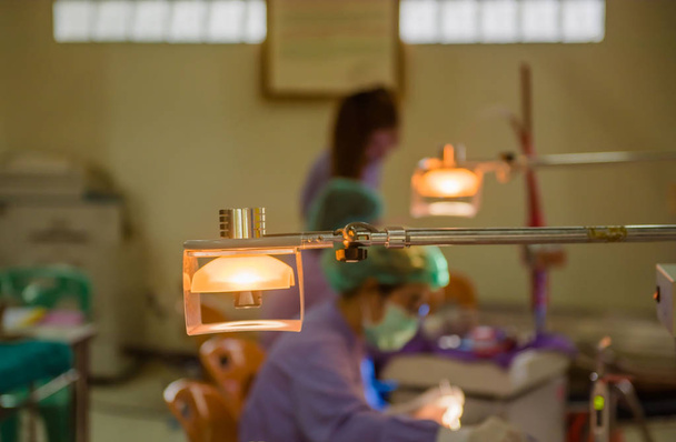 Lampes dans la salle dentaire et le médecin prend soin de l'arrière-plan du patient
 - Photo, image
