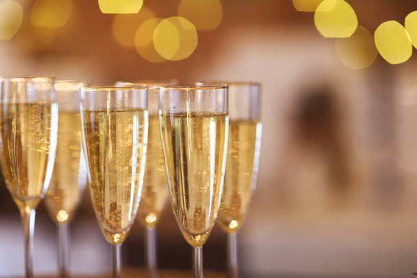 Champagne glasses on golden background  - Zdjęcie, obraz