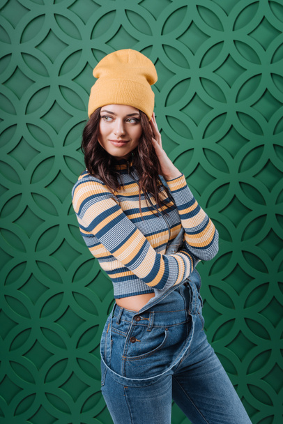 Woman posing in pullover, hat and overalls - Фото, зображення