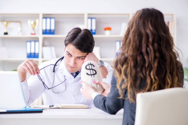 Young doctor in medical insurance fraud concept - Foto, imagen