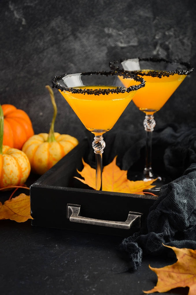 Fall seasonal cocktail Pumpkin Martini or Pumpkintini with black salt rim - Photo, Image