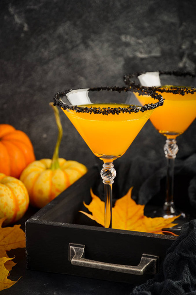 Fall seasonal cocktail Pumpkin Martini or Pumpkintini with black salt rim. - Photo, Image
