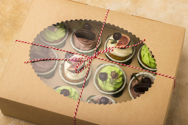 Delicious cupcakes in a box. Cupcakes with biscuits, figs, chocolate, marmalade. - Zdjęcie, obraz