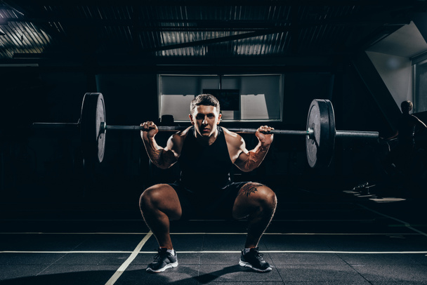 sportsman lifting a barbell  - Foto, afbeelding