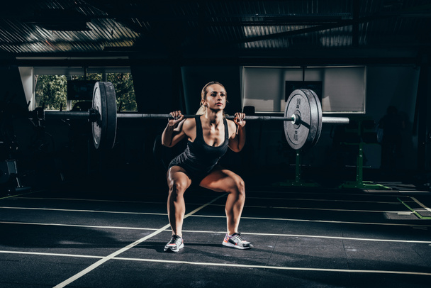 sportswoman lifting barbell - Photo, Image