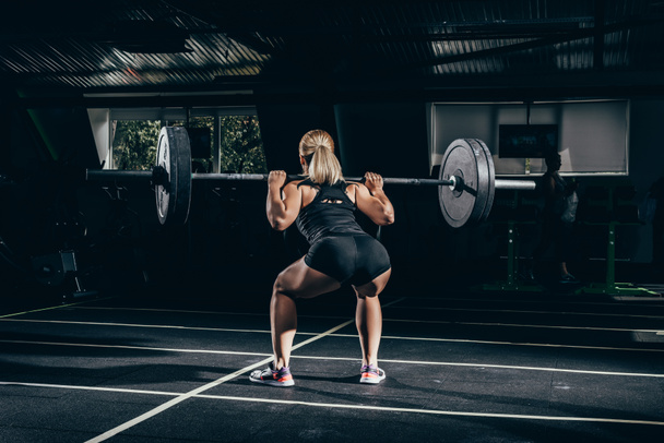 sportswoman lifting barbell - 写真・画像