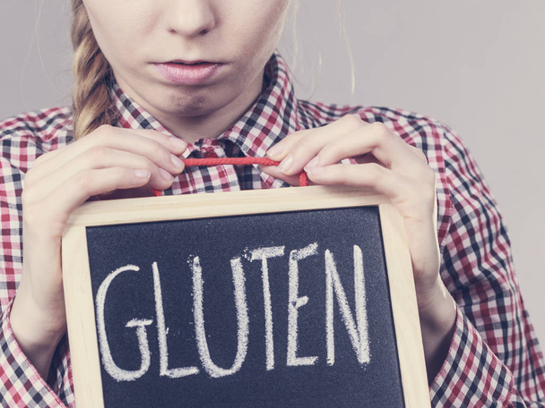Woman holding board with gluten sign - Φωτογραφία, εικόνα