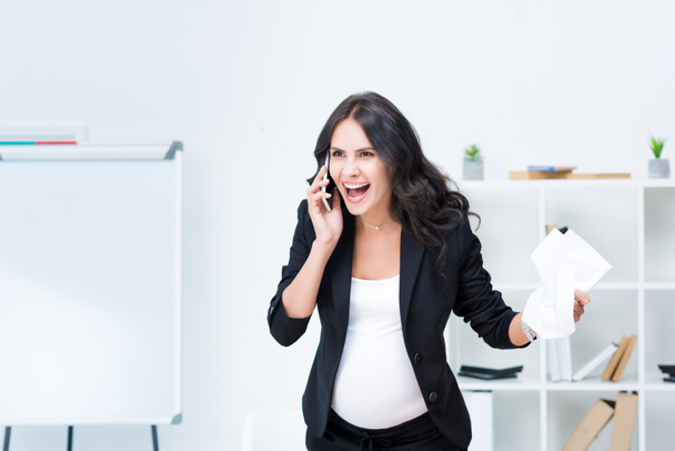 pregnant businesswoman shouting at phone - Photo, Image