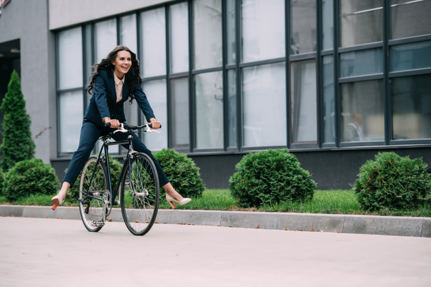 businesswoman riding bicycle - Фото, зображення
