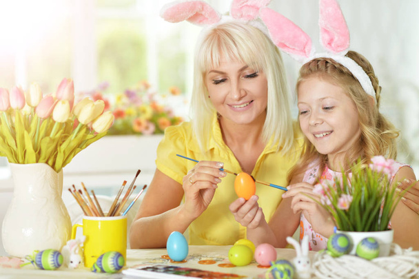 girl with mother painting eggs - Foto, Imagem