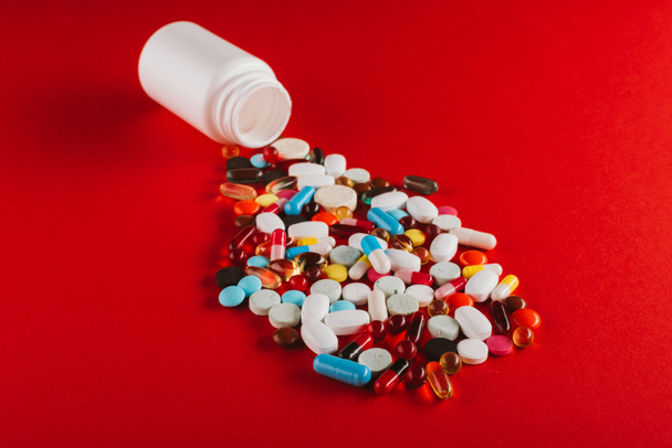 colorful pills and container - Foto, Imagem