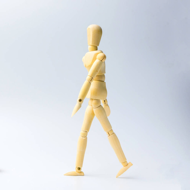 Wooden figure doll with walking action for business concept on w - 写真・画像