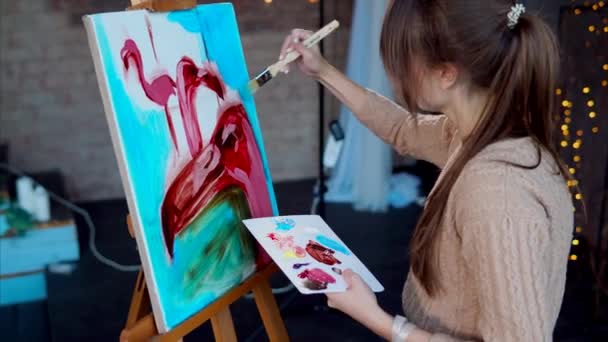 Young painter draws one of her pieces indoor. - Footage, Video