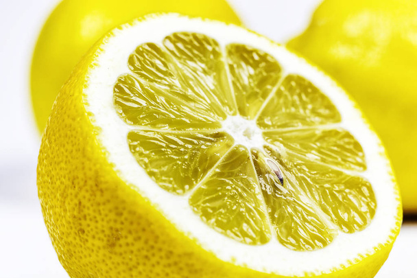 Half of a cut lemon close-up on a white background - Zdjęcie, obraz