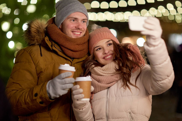 couple with coffee taking selfie at christmas - Foto, immagini