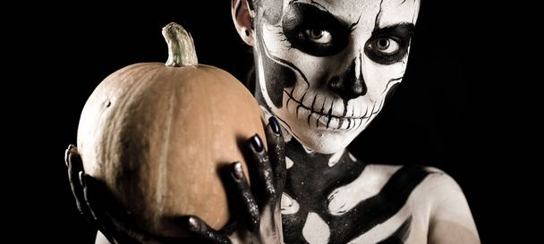 Woman with scull body art with pumpkin - Foto, Imagen