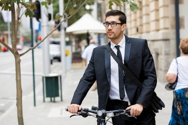 Young businessmen with a bike - Photo, Image