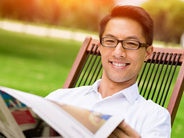 Business man reading a newspaper in park - Foto, Imagem