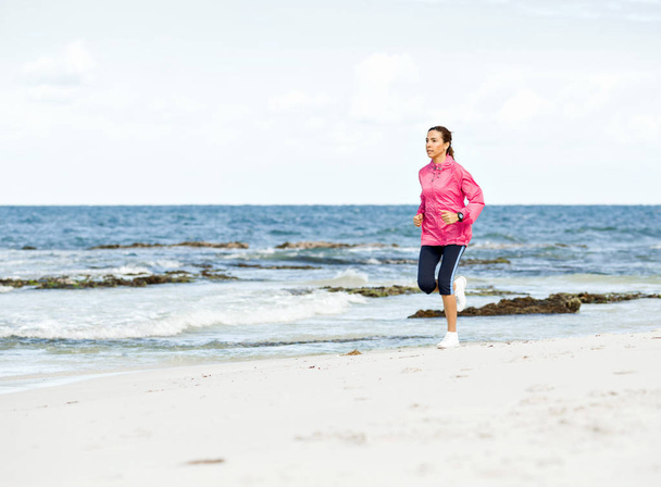 Young Woman Jogging On The Beach - Foto, Imagen