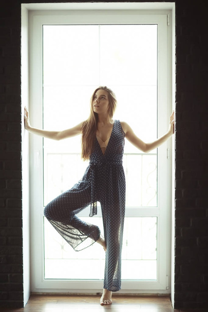 woman standing against window  - Foto, Imagem