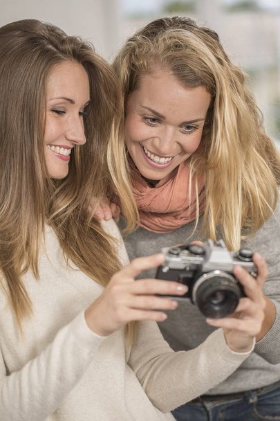Attractive girls taking selfie picture with vintage camera - Φωτογραφία, εικόνα