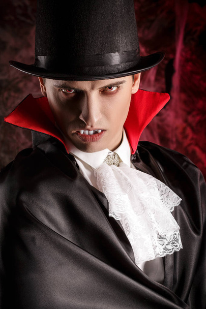 handsome man dressed in a Dracula costume for Halloween. - Zdjęcie, obraz