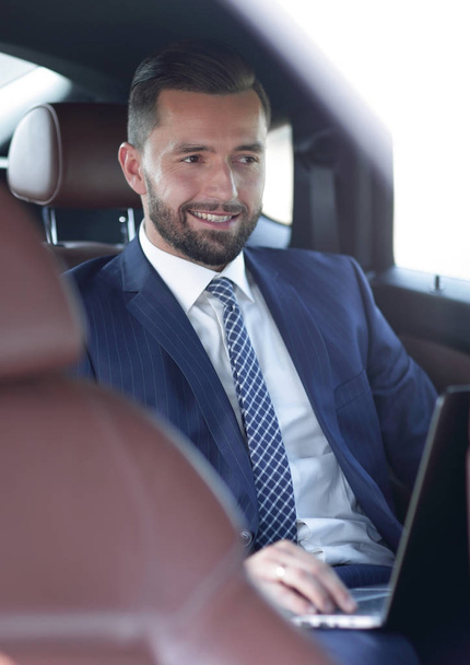 Portrait of a business man in the back seat of a car - Фото, изображение