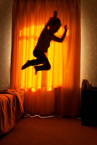 Boy sleepwalker jumping from bed - Photo, Image