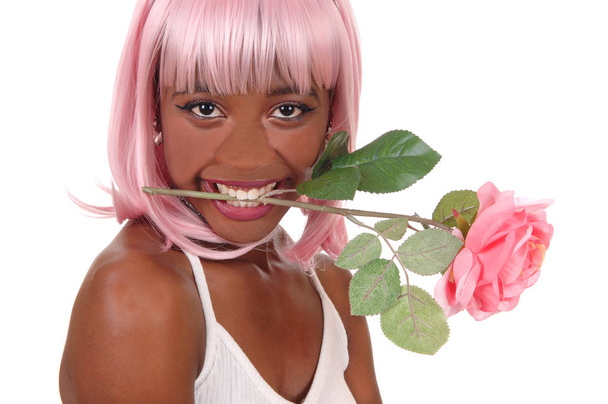 Closeup of woman with pink rose in mouth - Foto, afbeelding