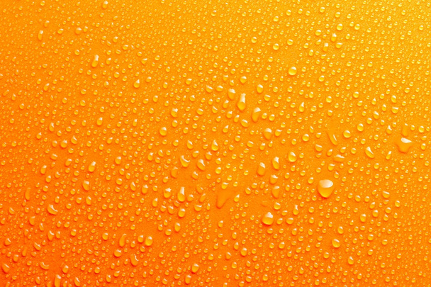 Капли воды на фоне оранжевого цвета
 - Фото, изображение