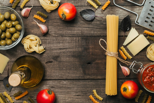 Fettuccine and spaghetti with ingredients for cooking pasta. Top view with space for text - Foto, Bild