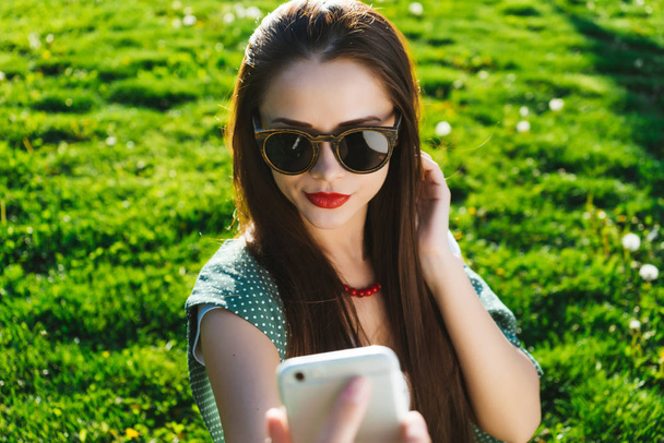 Woman doing selfie outside,copyspace, girl in sunglasses - Valokuva, kuva