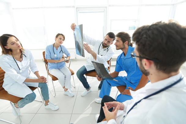 radiologists and a surgeon discussing a radiograph of a patient - Photo, Image
