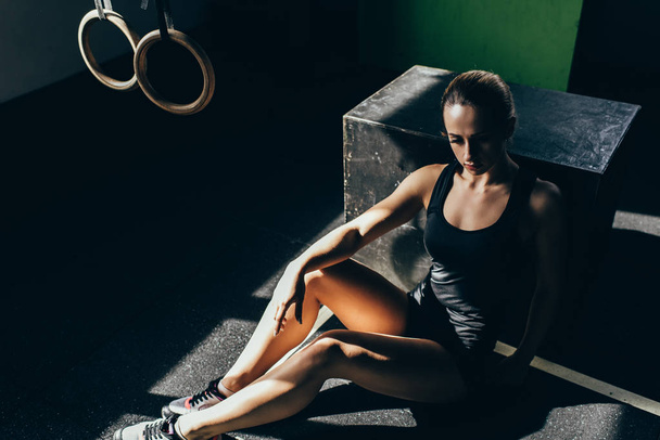 athletic sportswoman resting at gym - Фото, изображение