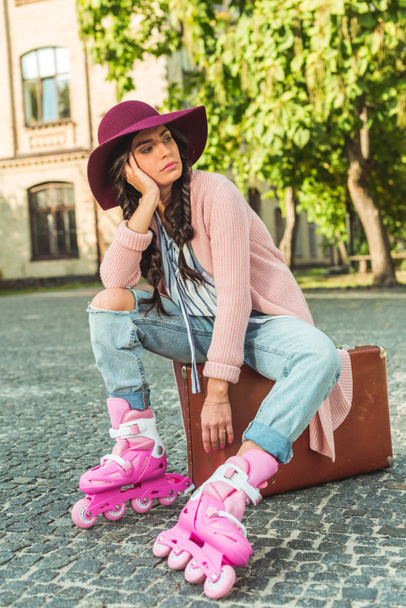 girl in roller skates with suitcase - 写真・画像