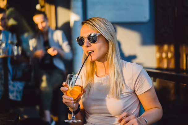 Woman drinking cocktail - Фото, изображение