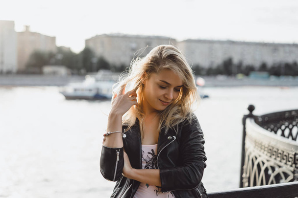 young blonde woman in black jacket outdoor - Photo, Image