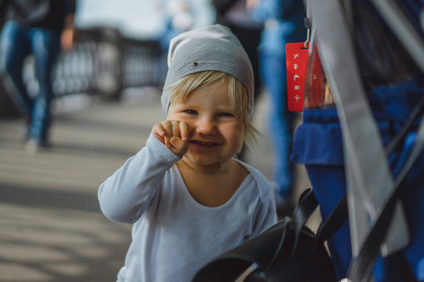 cute blonde boy in blue clothes outdoor - Fotoğraf, Görsel