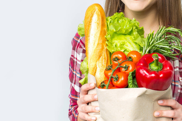 Beautiful woman holding paper bag with vegetables - Φωτογραφία, εικόνα