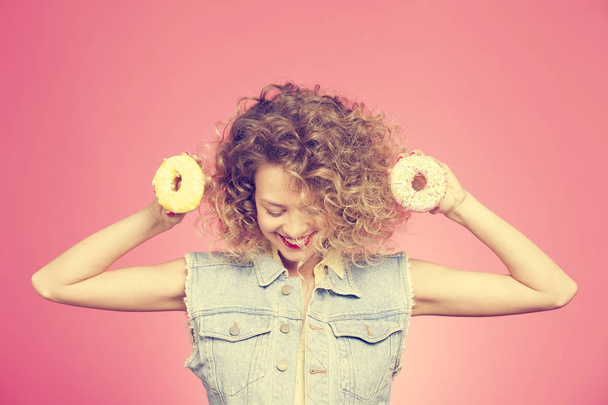 young woman holding donuts - 写真・画像