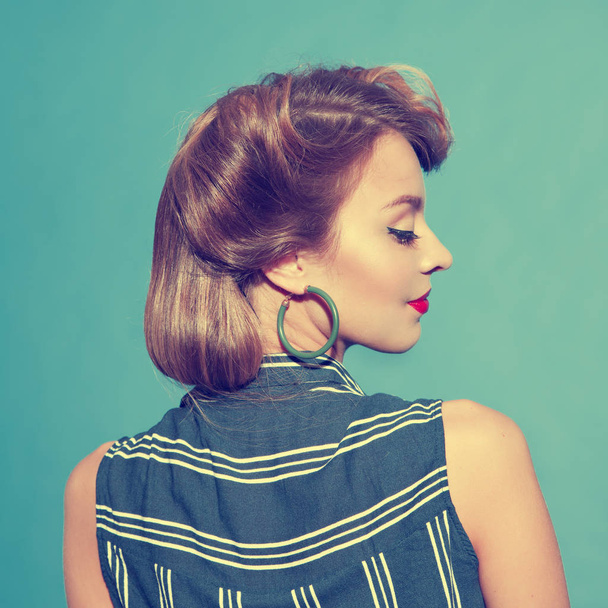 Back view of young woman with classical pin - up hairstyle - Foto, imagen