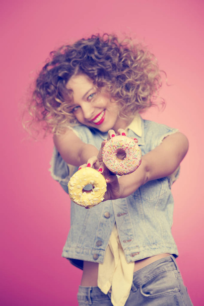 young woman holding donuts - Fotó, kép