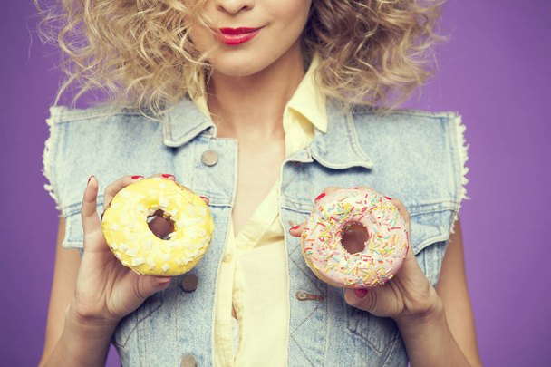 young woman holding donuts - Фото, изображение