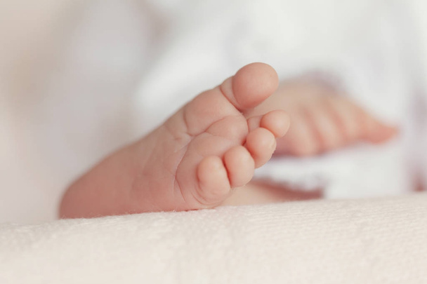 Close up of baby foot on blanket - Fotó, kép