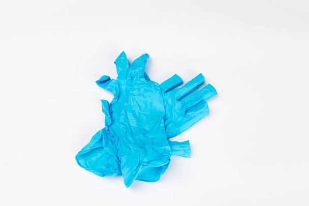 Blue medical gloves after use on white background - Foto, afbeelding