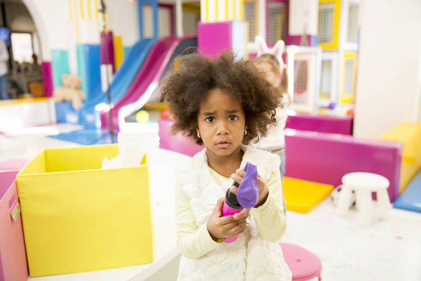 Cute african american little girl in playroom - Fotó, kép