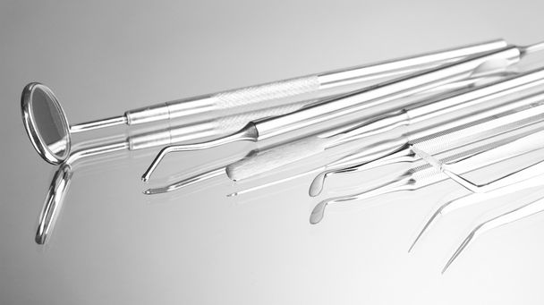 Set of dental tools for teeth care isolated on grey background - Photo, image