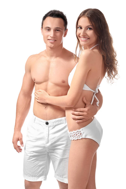 Young couple in beachwear on white background - Zdjęcie, obraz